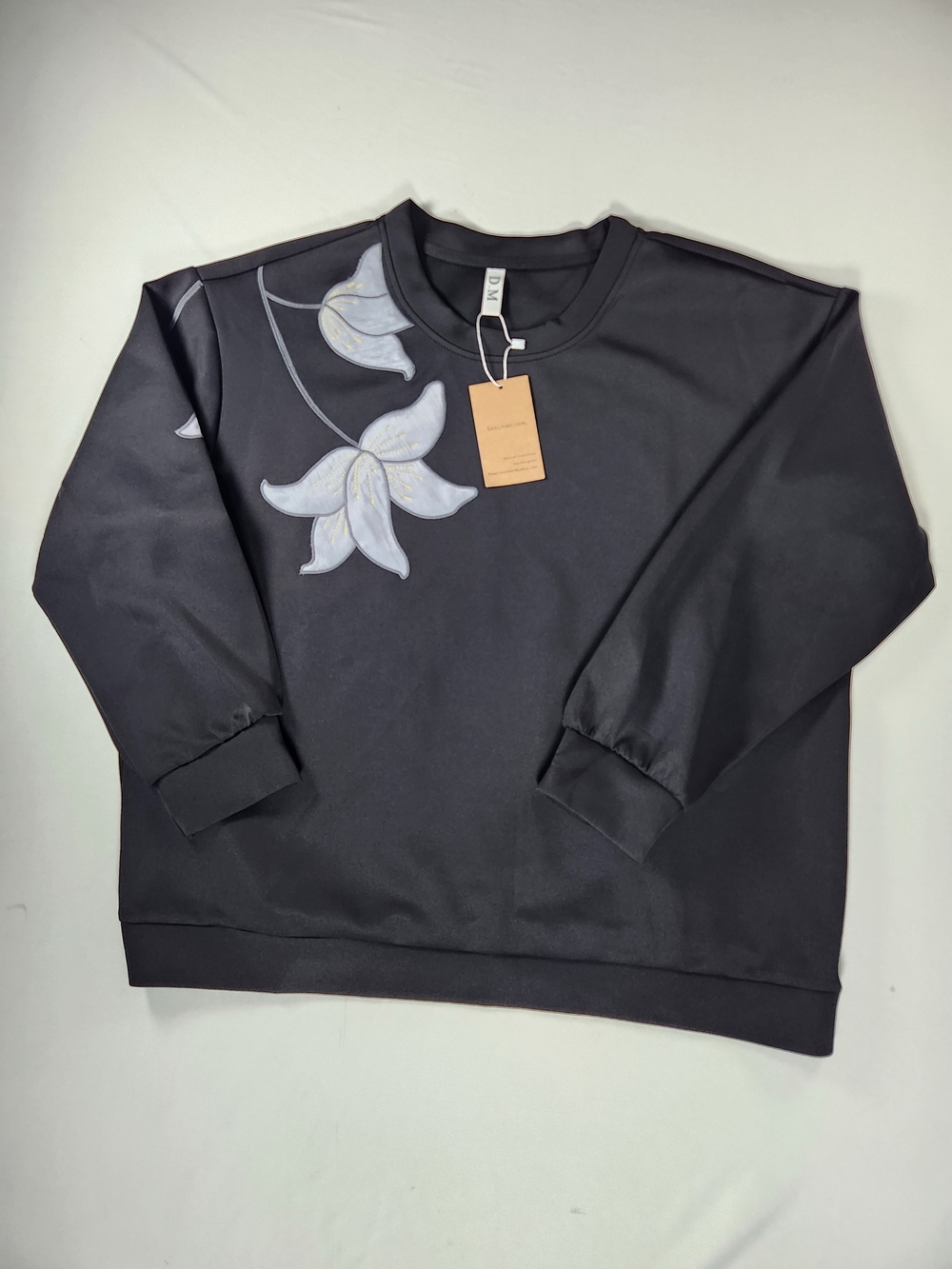 Women's Black Crewneck Sweater with White Floral Accent